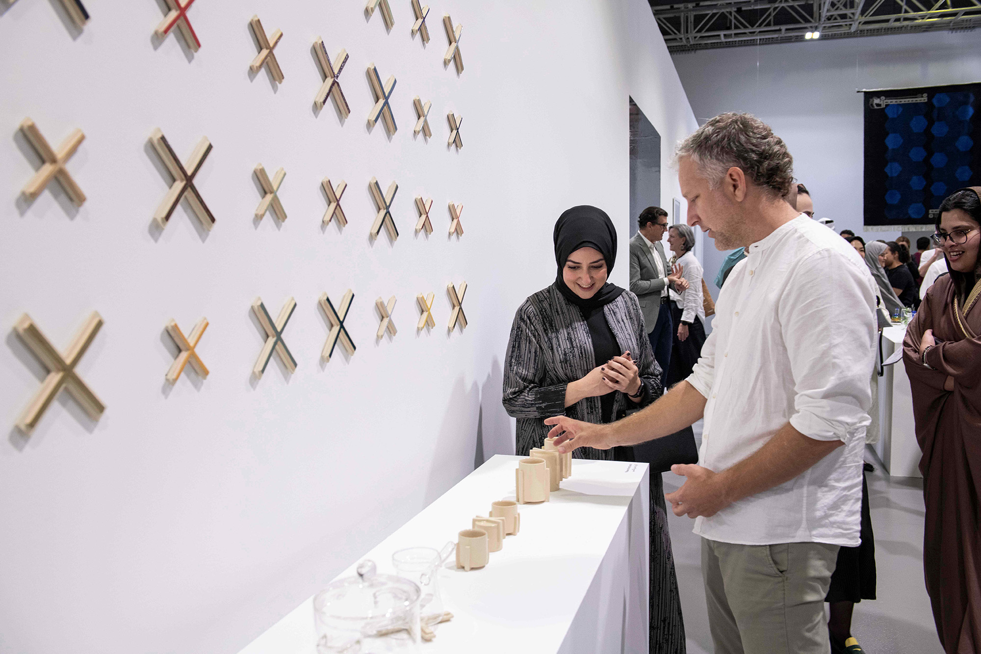 Yasmeen Suleiman showing her work to a visitor