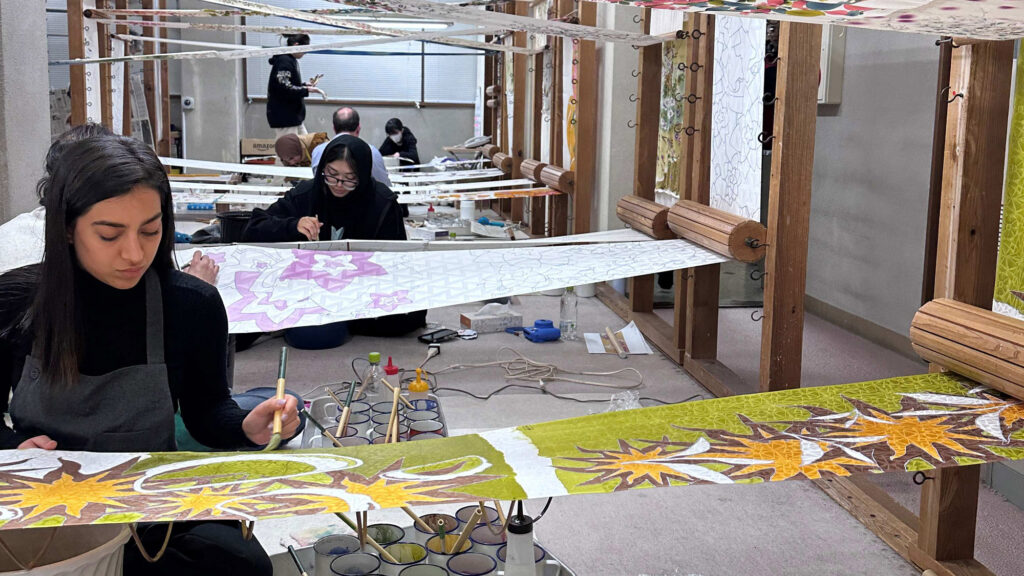 Students painting on silk