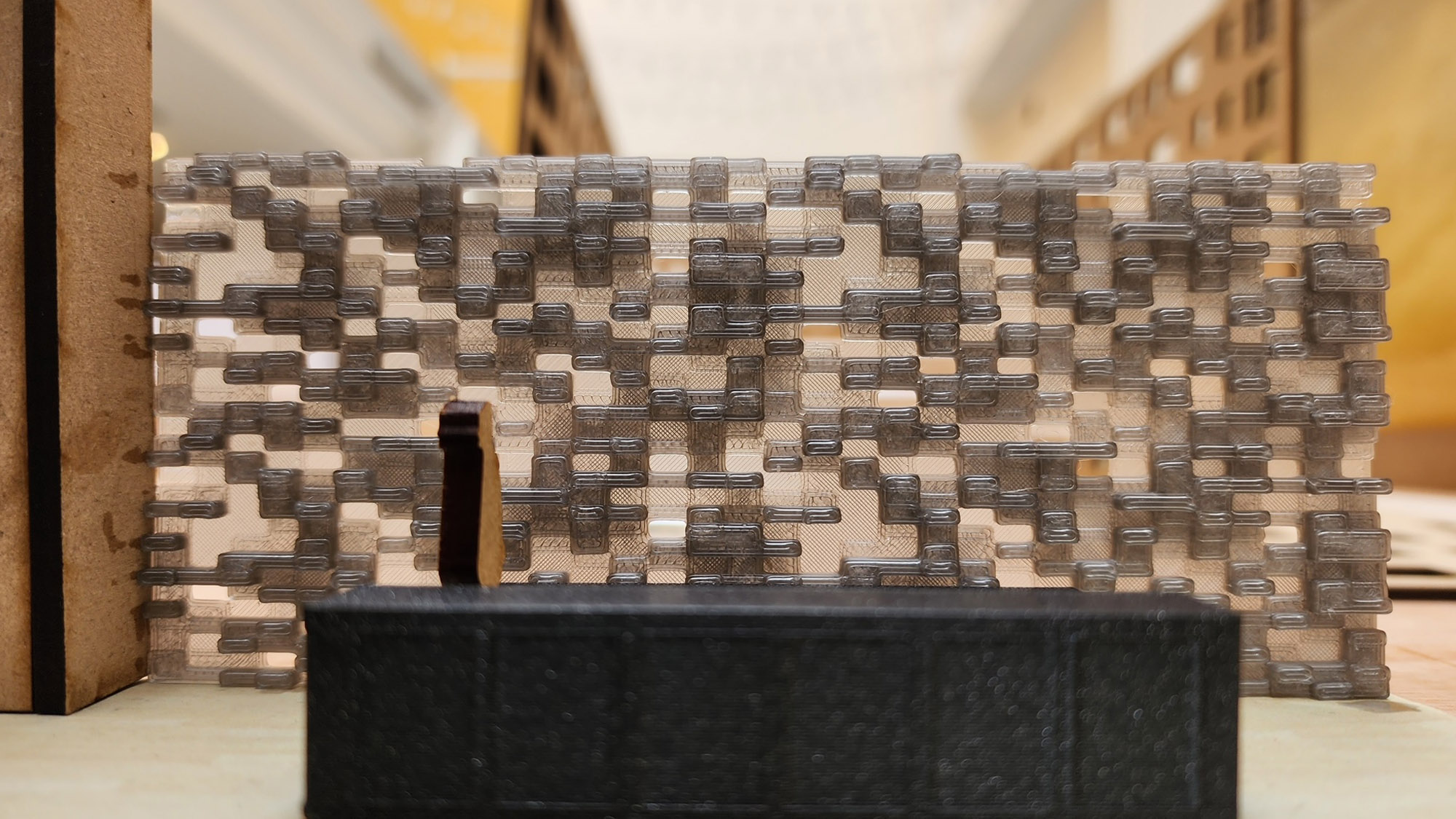 Close up of one of the models showing a reception desk in front of an interior brick wall