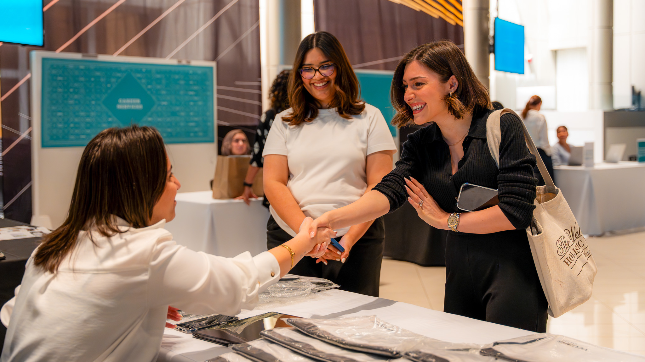 Students speaking to a staff member during the commencement fair.