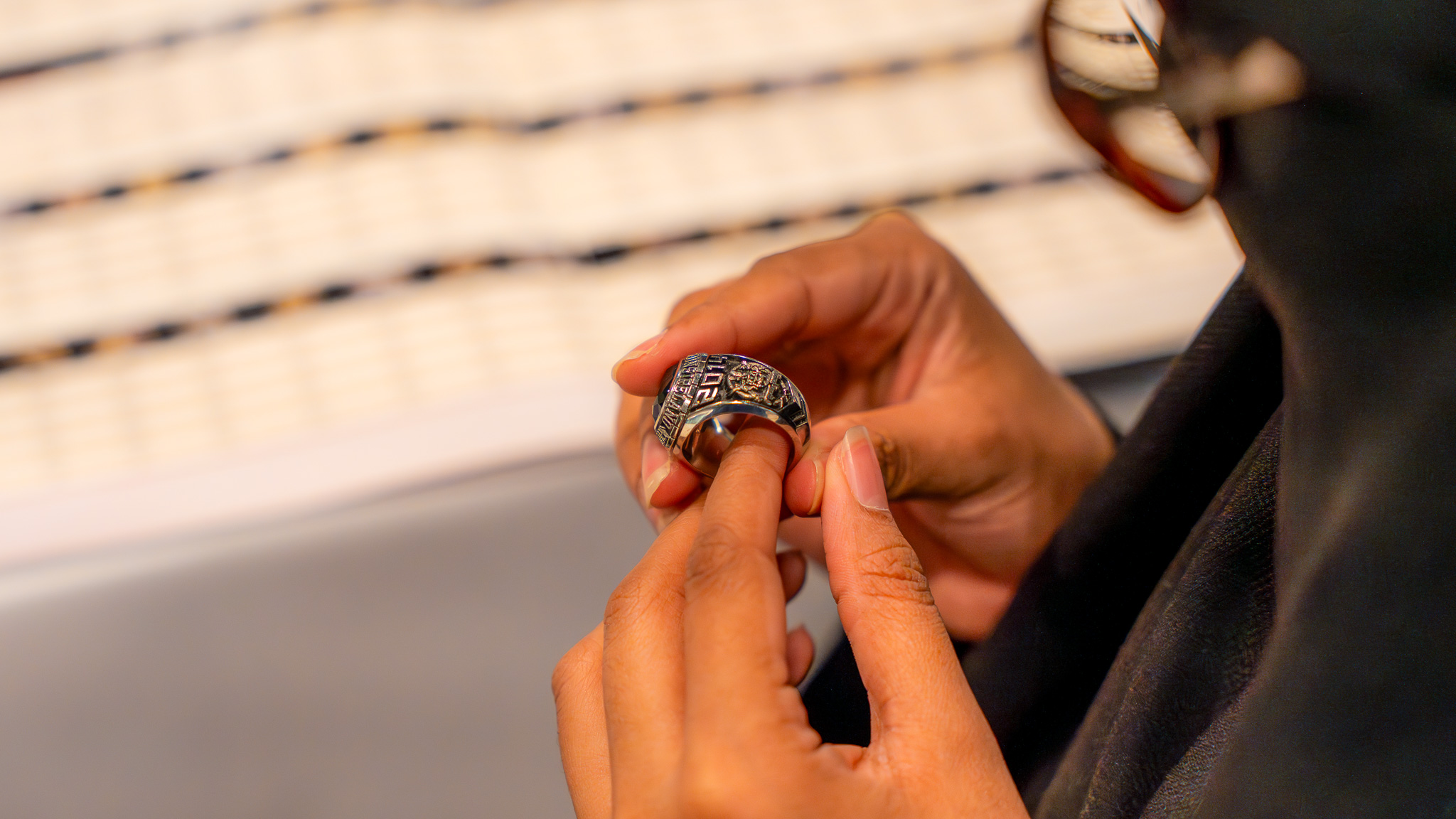 A student examining a class ring