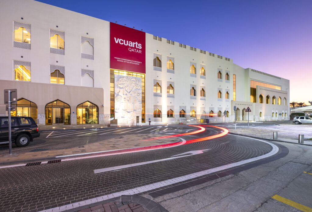 The exterior of the VCUarts Qatar building at night