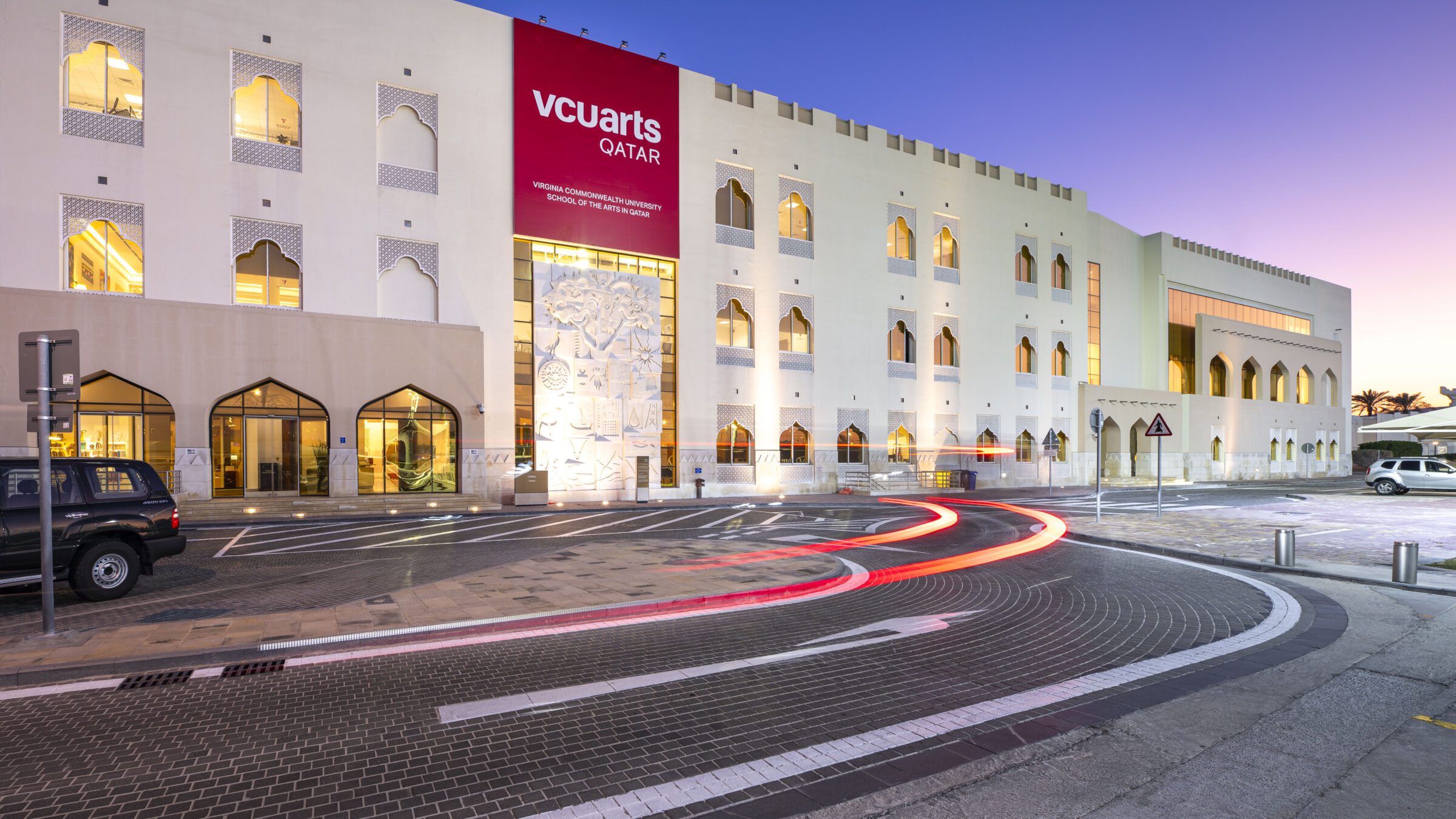 The exterior of the VCUarts Qatar building at night