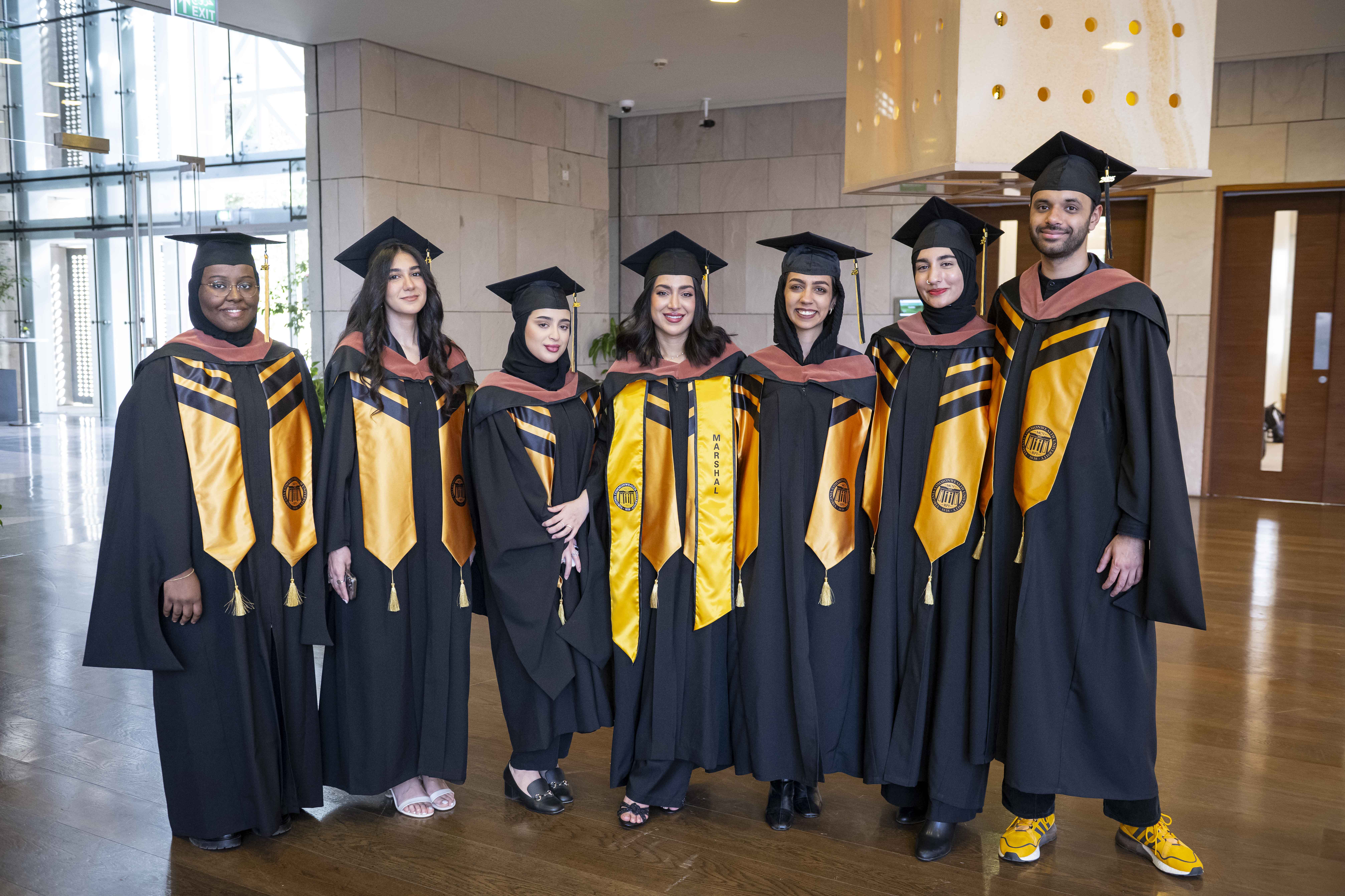 Students standing together for a group photo during commencement