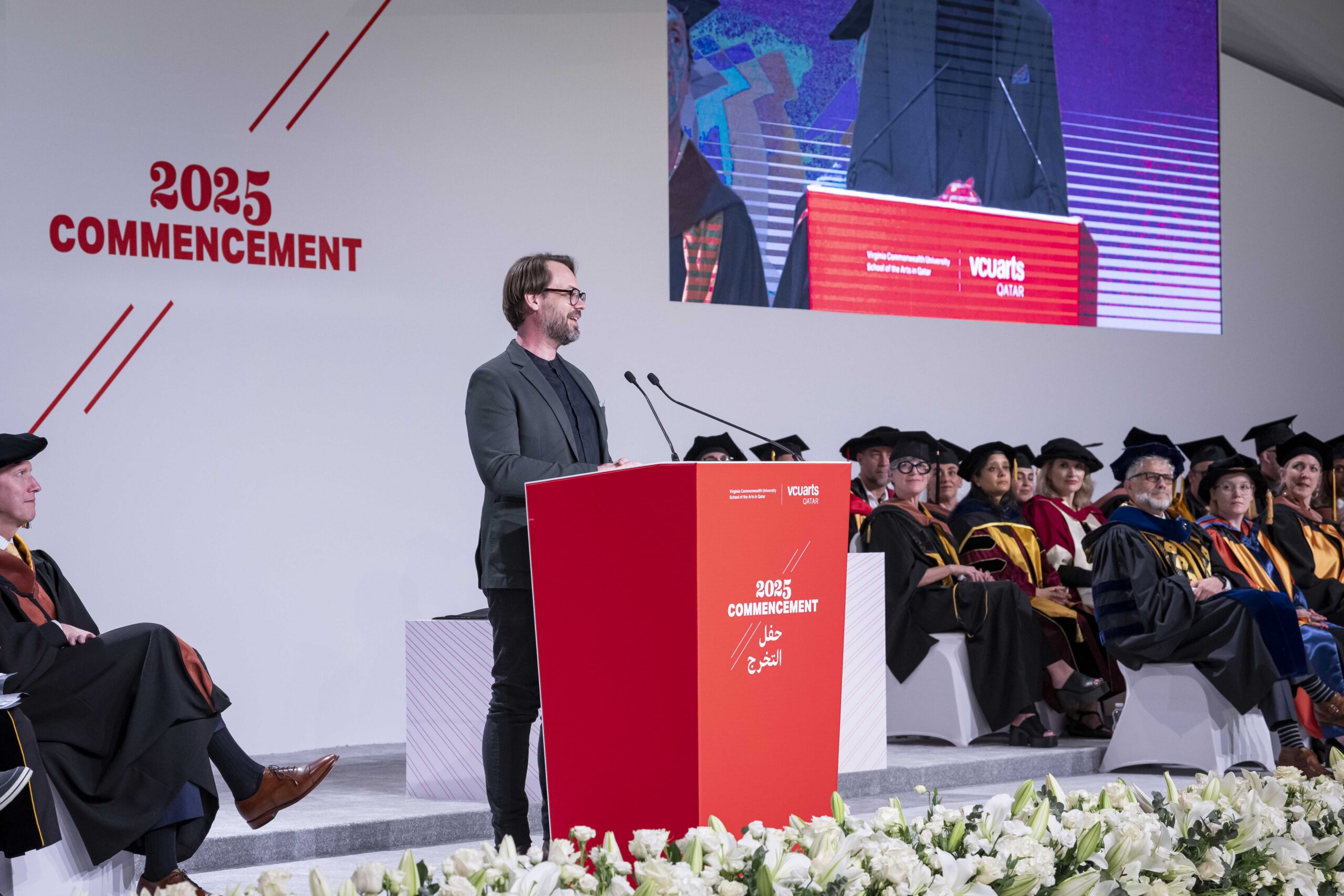 A speaker on stage during commencement